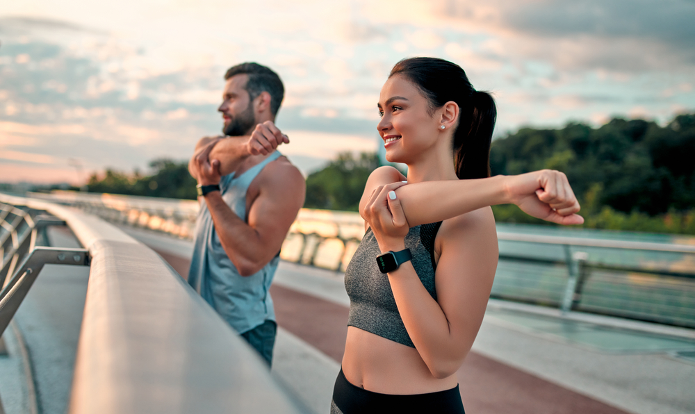 A man and woman are performing push-ups together in a gym - Chiropractor Langhorne PA