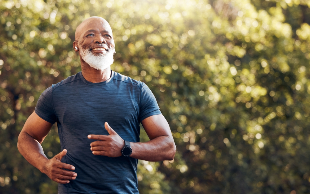 A man and woman wearing athletic gear give each other a high-five outdoors - Chiropractor Langhorne PA