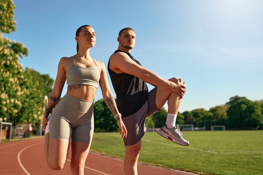 A man and woman are performing push-ups together in a gym - Chiropractor Langhorne PA